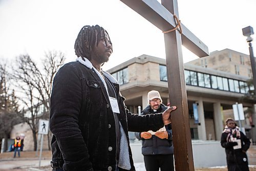 MIKAELA MACKENZIE / FREE PRESS

Paul Bahiga holds the cross before leading the Way of the Cross procession to the second station of the cross at the University of Manitoba on Friday, March 29, 2024. This is the first year that the event has been held on a university campus.

For Katie story.