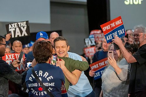 BROOK JONES / FREE PRESS
A supporter gives Conservative Party of Canada Leader Pierre Poilievre (baby blue colour T-shirt) gives a hug after being introduced to a crowd of 1,500 supporters during his 'Spike the Hike - Axe the Tax' rally at the RBC Convention Centre in Winnipeg, Man., Thursday, March 28, 2024.