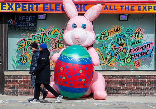 JOHN WOODS / FREE PRESS
People walk past an inflated Easter bunny outside a business on Portage Avenue  Sunday, March 31, 2024. 

Reporter: standup