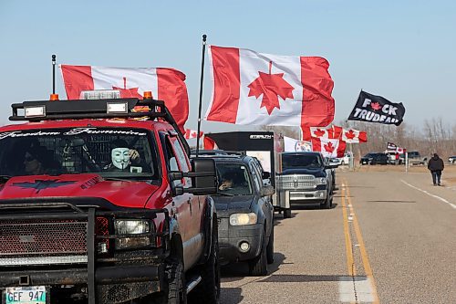 01042024
Protesters sit parked near the Trans-Canada Highway at the Manitoba-Saskatchewan border on Monday, including a vehicle with an upside-down Canadian flag. (Tim Smith/The Brandon Sun)