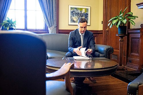 MIKAELA MACKENZIE / FREE PRESS

New Finance minister Adrien Sala looks over the budget binder in his office at the Manitoba Legislative Building on Thursday, March 28, 2024. 

For Dan story.