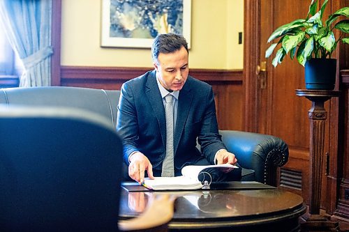 MIKAELA MACKENZIE / FREE PRESS

New Finance minister Adrien Sala looks over the budget binder in his office at the Manitoba Legislative Building on Thursday, March 28, 2024. 

For Dan story.