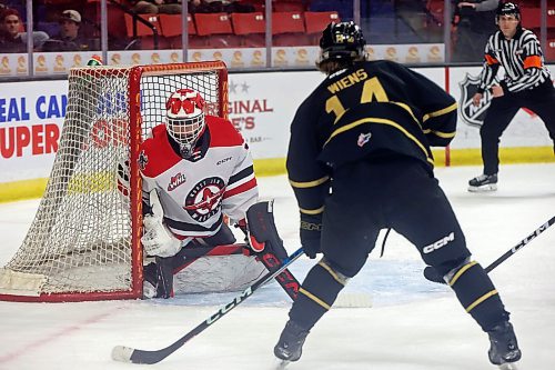 03042023
Jayden Wiens #14 of the Brandon Wheat Kings tries to get the puck past goalie Jackson Unger #30 of the Moose Jaw Warriors during the first period of game three of first round playoff action at Westoba Place on Wednesday evening. 
(Tim Smith/The Brandon Sun)