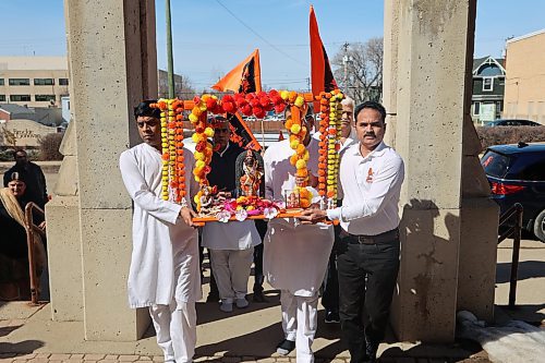 Shailesh Patel (left) and Shambhu Patel carry Shri Ram Rath Yatra into Brandon's BAPS Mandir at 327 Eighth St. on Thursday. (Abiola Odutola/The Brandon Sun)
