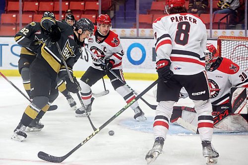 Rylen Roersma of the Brandon Wheat Kings eyes the loose puck in front of netminder Jackson Unger of the Moose Jaw Warriors during the first period of Game 4 of their Western Hockey League series at Westoba Place on Wednesday evening. (Tim Smith/The Brandon Sun)