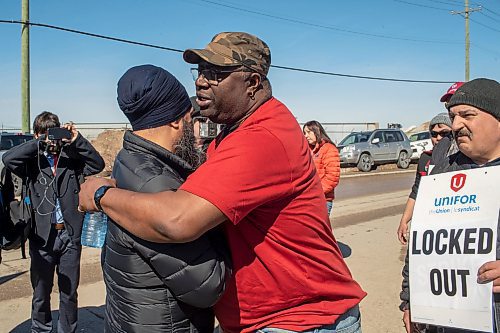 BROOK JONES / FREE PRESS
Teddy Olukoya (right) who has been working for Griffin Wheel Company for 12 years gives Canada's NDP Leader Jagmeet Singh a hug. Olukoya was on the picket line with fellow workers, Unifor Local 144, while they fight for fair benefits and pensions. Singh was pictured with striking workers from this train wheel manufacturing plant in Winnipeg, Man., Thursday, April 4, 2024.
