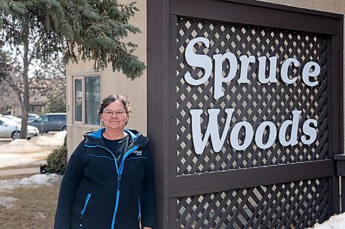Eva Cameron, manager of the Spruce Woods Housing Co-op on Braecrest Drive in Brandon, stands near the complex's sign on Friday afternoon. Cameron said she was glad to hear the provincial government announce funds aimed at helping maintain existing affordable housing like the co-op on Thursday. (Colin Slark/The Brandon Sun)