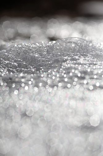 Bubbles glinting in the bright sunshine go with the flow on top of meltwater in a ditch down Grandvalley Road west of Brandon on Friday morning. (Matt Goerzen/The Brandon Sun)