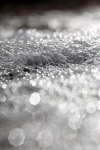 Bubbles glinting in the bright sunshine go with the flow on top of meltwater in a ditch down Grandvalley Road west of Brandon on Friday morning. (Matt Goerzen/The Brandon Sun)