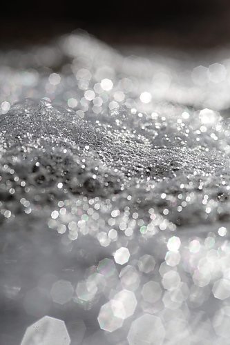 Bubbles glinting in the bright sunshine go with the flow on top of meltwater in a ditch down Grandvalley Road west of Brandon on Friday morning. (Matt Goerzen/The Brandon Sun)