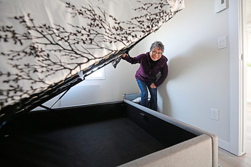 Glendale Homes park owner Cindy Choy lifts up a bed in a newly-constructed single-bedroom home on Brandon's North Hill, to show the storage space under the mattress. Choy advertises the park as Brandon's first Pocket Neighbourhood, with small energy-efficient homes that come with highly insulated walls, roofs and floors, LED lighting, triple-pane windows, and modern equipment for those who want efficient, green living. (Matt Goerzen/The Brandon Sun)