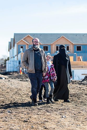 MIKAELA MACKENZIE / FREE PRESS

Aslan (left), Halima (nine), and Eljifa Sejdi in front of the under-construction Habitat for Humanity housing development that they will be moving into in Transcona on Friday, April 5, 2024. Six in 10 Winnipeggers are in favour of the city&#x573; decision late last year to loosen zoning laws that would allow four housing units be built on a what was typically a single residential lot.

For Kevin story.