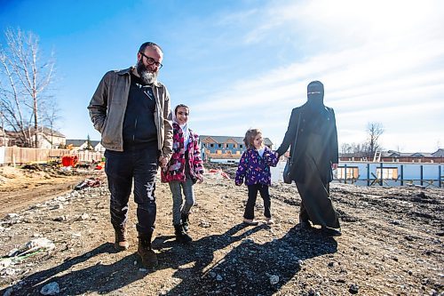 MIKAELA MACKENZIE / FREE PRESS

Aslan (left), Halima (nine), Zainab (five), and Eljifa Sejdi in front of the under-construction Habitat for Humanity housing development that they will be moving into in Transcona on Friday, April 5, 2024. Six in 10 Winnipeggers are in favour of the city&#x573; decision late last year to loosen zoning laws that would allow four housing units be built on a what was typically a single residential lot.

For Kevin story.
