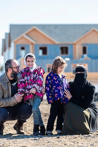 MIKAELA MACKENZIE / FREE PRESS

Aslan (left), Halima (nine), Zainab (five), and Eljifa Sejdi in front of the under-construction Habitat for Humanity housing development that they will be moving into in Transcona on Friday, April 5, 2024. Six in 10 Winnipeggers are in favour of the city&#x573; decision late last year to loosen zoning laws that would allow four housing units be built on a what was typically a single residential lot.

For Kevin story.