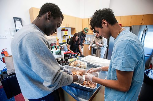JOHN WOODS / FREE PRESS
Volunteers with CommUNITY204, Emmanuel, left, Allen, and University of Winnipeg Students Association (UWSA) prepare food for homeless people in the community at Thunderbird House Sunday, April 7, 2024. 

Reporter: standup
