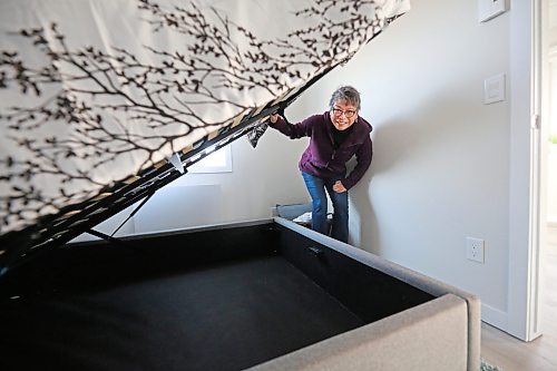 Glendale Homes park owner Cindy Choy lifts up a bed in a newly-constructed single-bedroom home on Brandon's North Hill, to show the storage space under the mattress. Choy advertises the park as Brandon's first Pocket Neighbourhood, with small energy-efficient homes that come with highly insulated walls, roofs and floors, LED lighting, triple-pane windows, and modern equipment for those who want efficient, green living. (Matt Goerzen/The Brandon Sun)