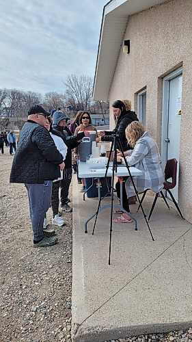 People in Neepawa line up for coffee and eclipse-viewing safety glasses at the Flats in Neepawa on the day of the solar eclipse, April 8. (Miranda Leybourne/The Brandon Sun)