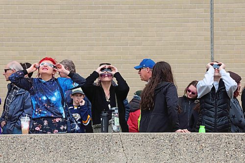 08042024
Brandonites take turns using special glasses to watch the solar eclipse during breaks in the cloud cover on Monday afternoon during a viewing party at Brandon University. 
(Tim Smith/The Brandon Sun)