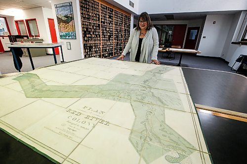 JOHN WOODS / FREE PRESS
Kathleen Epp, keeper at the Manitoba Archives, displays a Red River Colony map from 1836-38 in the Hudson&#x2019;s Bay Archives collection at the Manitoba Archives in Winnipeg  Monday, April 8, 2024. Archives Manitoba is having an open house Friday and Saturday and will be displaying three dozen maps dating back to 1709.

Reporter: kevin