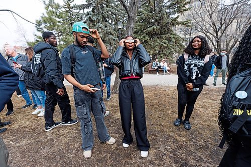 MIKE DEAL / FREE PRESS
Emnanuella Jatau, a Physical Geography student, puts on a pair of eclipse glasses as hundreds of students gather on the Quad at the University of Manitoba to watch the partial solar eclipse during an overcast Monday afternoon.
240408 - Monday, April 08, 2024.