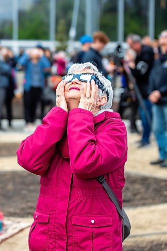 MIKAELA MACKENZIE / FREE PRESS
	
Joanne Ursell looks through her eclipse glasses at the solar eclipse viewing party at The Leaf in Assiniboine Park on Monday, April 8, 2024. 

For Nicole story.