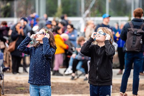 MIKAELA MACKENZIE / FREE PRESS
	
Meaghan Hammond (left, 12) and Levi Russell (11) look through their eclipse glasses at the solar eclipse viewing party at The Leaf in Assiniboine Park on Monday, April 8, 2024. 

For Nicole story.