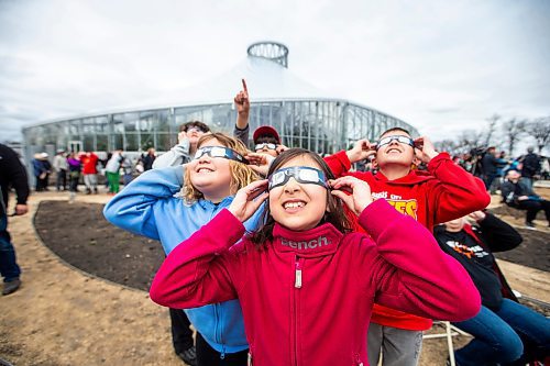 MIKAELA MACKENZIE / FREE PRESS
	
Kara Ritchot (centre, eight) and her cousins look through their eclipse glasses at the solar eclipse viewing party at The Leaf in Assiniboine Park on Monday, April 8, 2024. 

For Nicole story.