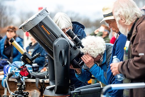 MIKAELA MACKENZIE / FREE PRESS
	
Ed Rajfur, with the Royal Astronomical Society, looks through his telescopes at the solar eclipse viewing party at The Leaf in Assiniboine Park on Monday, April 8, 2024. 

For Nicole story.