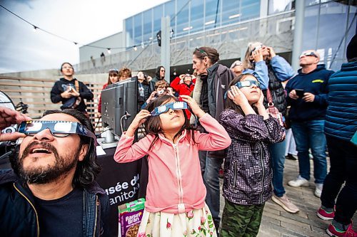 MIKAELA MACKENZIE / FREE PRESS
	
Rafael (left), Isabel (six), and Gabriel (eight) Reyes look through their eclipse glasses at the solar eclipse viewing party at The Leaf in Assiniboine Park on Monday, April 8, 2024. 

For Nicole story.