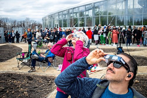 MIKAELA MACKENZIE / FREE PRESS
	
Joanne Ursell looks through her eclipse glasses at the solar eclipse viewing party at The Leaf in Assiniboine Park on Monday, April 8, 2024. 

For Nicole story.