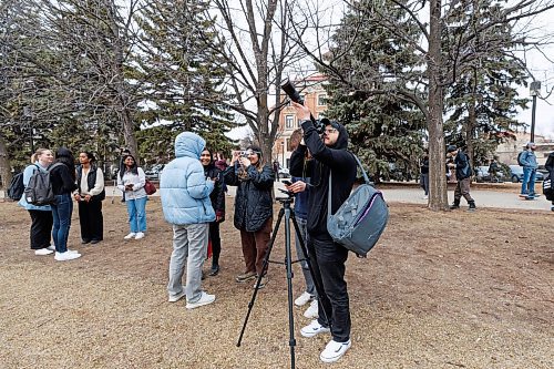 MIKE DEAL / FREE PRESS
Walid Anan a Computer Science student, uses his cameral to take photos of the partial eclipse at the UofM.
Students gather on the Quad at the University of Manitoba to collect free viewing glasses and watch the partial solar eclipse during an overcast Monday afternoon.
240408 - Monday, April 08, 2024.