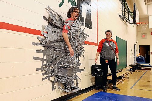 09042024
Students at &#xc9;cole Harrison celebrate after duct-taping vice principal Shawn Lehman to the gymnasium wall during an assembly fundraiser for the family of eleven-year-old grade-six student Jesse Olson on Tuesday. After a battle with cancer, Olson is now cancer-free and the school sold strips of duck-tape to stick Lehman to the wall as a way of raising funds for Olson&#x2019;s family. Students also donated for the chance to be picked to pie staff members with whip-cream pies during the assembly. 
(Tim Smith/The Brandon Sun)