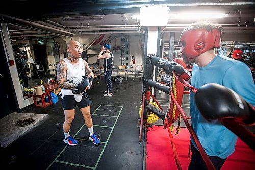 JOHN WOODS / FREE PRESS
Chris Sarifa, co-manager, left, gives advice to Michael McMillan, who is sparring for the first time at Pan Am Place, a half-way house for men, Tuesday, April 8, 2024. 

Reporter: conrad