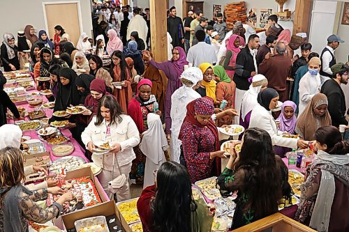 Members of Brandon’s Muslim community help themselves to a feast after prayers for Eid al-Fitr. (Tim Smith/The Brandon Sun)