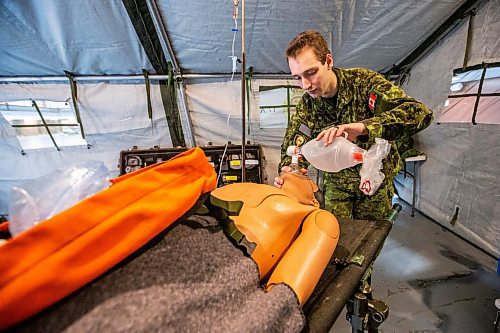 MIKAELA MACKENZIE / FREE PRESS
	
Private George McKeever demonstrates securing an airway and helping a patient breathe in a mobile medical treatment facility during an open house, which is hoping to aid army recruitment efforts, at Minto Armouries on Thursday, April 11, 2024.

Standup.
