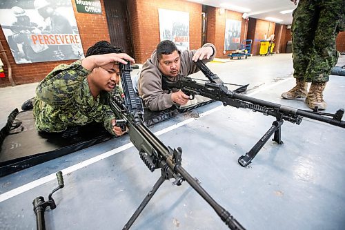 MIKAELA MACKENZIE / FREE PRESS
Corporal Van Mang (left) demonstrates infanteer weaponry (C6 and C9 machine guns) to Mark Requinta during an open house, which is hoping to aid army recruitment efforts, at Minto Armouries on Thursday, April 11, 2024.
Standup.