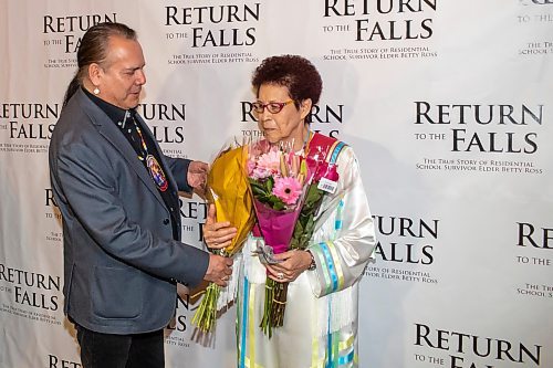 BROOK JONES / FREE PRESS
Manitoba Keewatinowi Okimakanak Grand Chief Garrison Settee (left) presenting Elder Betty Ross with flowers at the red carpet gala during the screening of Return to the Falls, which is a docudrama following the life story of Ross, who is a residential school survivor, at the Park Theatre in Winnipeg, Man., Wednesday, April 10, 2024. The red carpet gala was hosted by Cross Lake First Nation and Black Badge Studios.