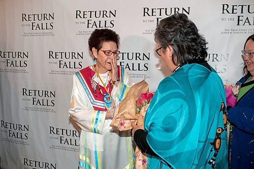 BROOK JONES / FREE PRESS
Elder Betty Ross (left) reacts with emotion as Dee Thomas (middle) and Bonnie Kehler (right) present her with flowers at the red carpet gala during the screening of Return to the Falls, which is a docudrama following the life story of Ross, who is a residential school survivor, at the Park Theatre in Winnipeg, Man., Wednesday, April 10, 2024. The red carpet gala was hosted by Cross Lake First Nation and Black Badge Studios.