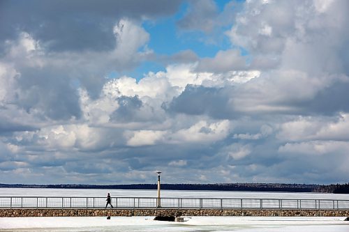 11042024
A boy walks along the pier over a still ice-covered Clear Lake in Riding Mountain National Park on a mild Thursday. 
(Tim Smith/The Brandon Sun)