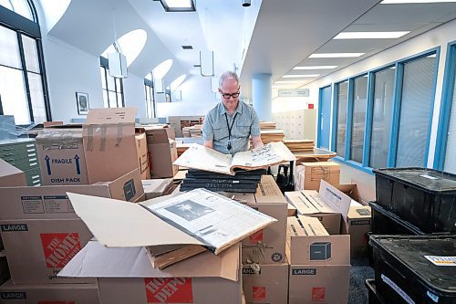 Stuart Hay, the Manitoba Legislative Library's head of reference services, reads a page from a vintage Brandon Sun on Friday. The Sun archives collection has been relocated to the legislative library on Vaughan Street in Winnipeg. (Ruth Bonnevile/Winnipeg Free Press)

