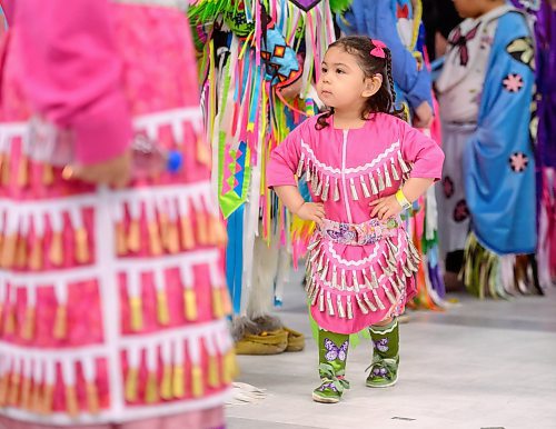 Mike Sudoma /  Free Press
2 year old Zoraida Morisseau watches the older dancers as she performs in her first Powwow Friday afternoon at the Manitoba Institute for Trades and Technology
April 12, 2024