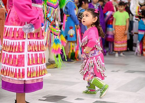 Mike Sudoma /  Free Press
2 year old Zoraida Morisseau watches the older dancers as she performs in her first Powwow Friday afternoon at the Manitoba Institute for Trades and Technology
April 12, 2024