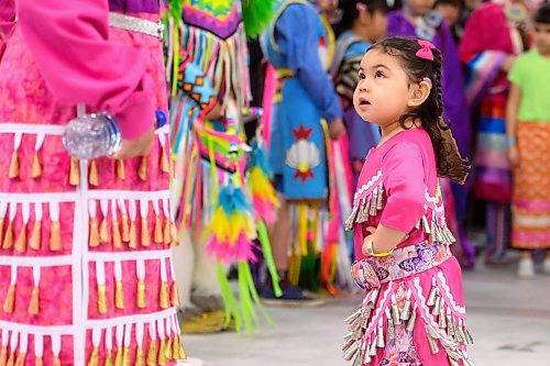 Mike Sudoma /  Free Press
2 year old Zoraida Morisseau watches the older dancers as she performs in her first Powwow Friday afternoon at the Manitoba Institute for Trades and Technology
April 12, 2024