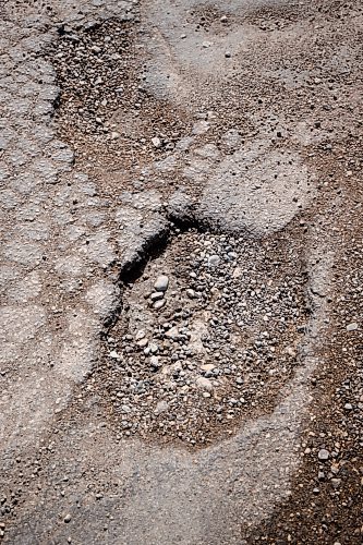 Mike Sudoma / Free Press
One of the many large potholes along the corner of Broadway and Memorial Blvd Friday afternoon
April 12, 2024