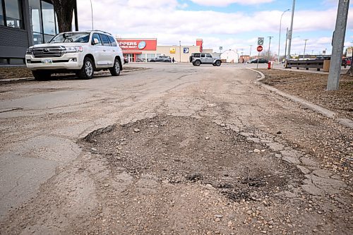 Mike Sudoma / Free Press
A large pothole on Lenore St as cars drive along Portage Avenue in the distance
April 12, 2024