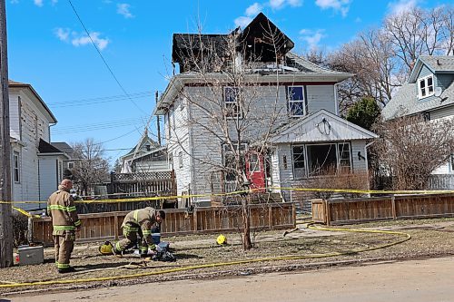 Members of Brandon Fire and Emergency Services remained on scene at a Second Street home on Saturday after it caught fire that morning. No injuries have been reported and three cats were saved. (Geena Mortfield/The Brandon Sun)
