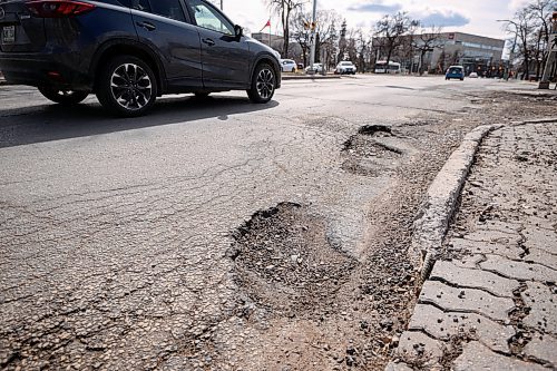 Mike Sudoma / Free Press
Drivers avoid the long line of potholes at the corner of Broadway and Memorial Blvd Friday afternoon
April 12, 2024