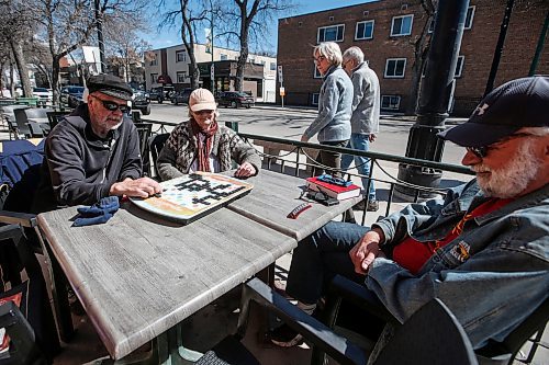 JOHN WOODS / FREE PRESS
Tim Brandt, Di Harms, and Les Brandt enjoy the spring weather with some Scrabble on a Corydon Avenue patio Sunday, April 14, 2024. 

Reporter: tyler