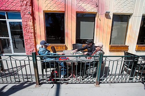 JOHN WOODS / FREE PRESS
Tim Brandt, Di Harms, and Les Brandt enjoy the spring weather with some Scrabble on a Corydon Avenue patio Sunday, April 14, 2024. 

Reporter: tyler