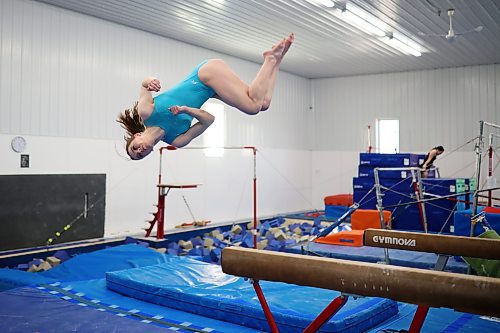 Maribell Teeple flips off of the beam while training last week. (Tim Smith/The Brandon Sun)